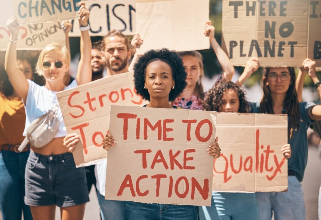 Group, protest and portrait in street, poster or climate change with march, walking or together for